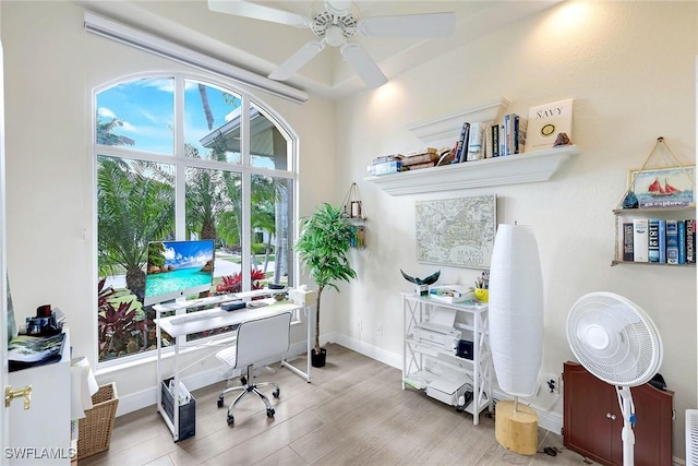 office with light hardwood / wood-style floors and ceiling fan