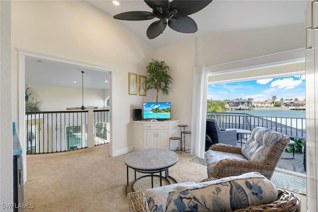 living room with vaulted ceiling, carpet, baseboards, and ceiling fan