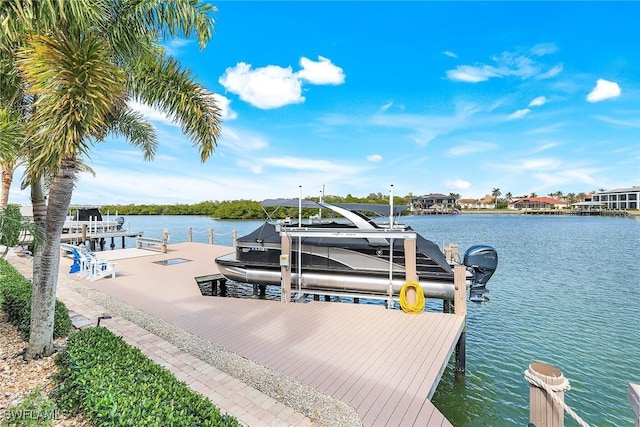 dock area with a water view and boat lift