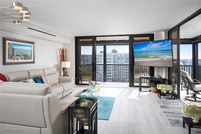 living room with expansive windows, a wealth of natural light, and light hardwood / wood-style flooring