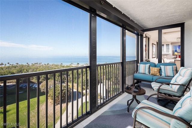 sunroom / solarium with a water view