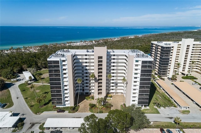 drone / aerial view featuring a view of the beach and a water view