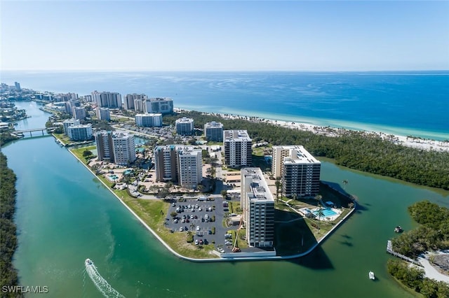 birds eye view of property featuring a water view and a beach view