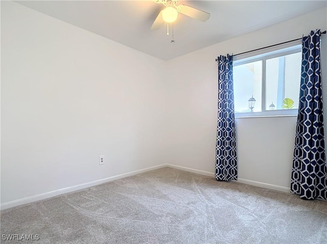 carpeted spare room with ceiling fan