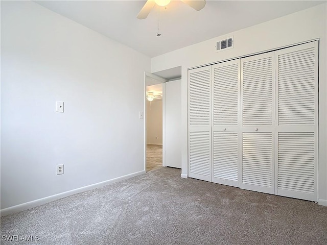 unfurnished bedroom featuring a closet, carpet flooring, and ceiling fan