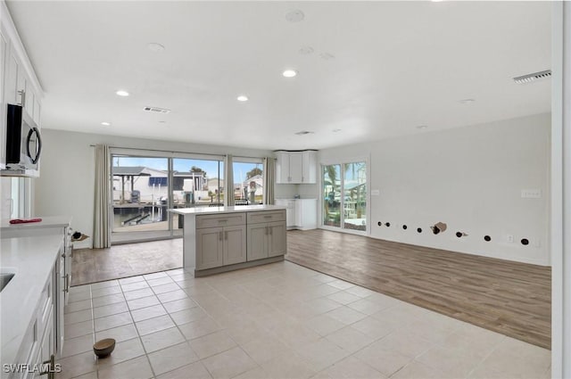 kitchen featuring a center island, white cabinetry, and light tile patterned floors