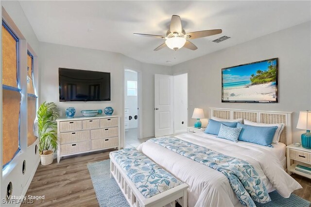 bedroom with ceiling fan, connected bathroom, and light hardwood / wood-style flooring