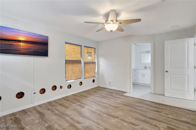 laundry room featuring light hardwood / wood-style floors, sink, and ceiling fan