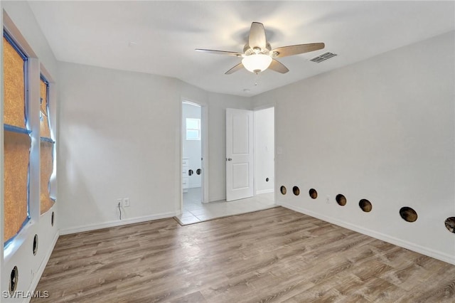 unfurnished room featuring light wood-type flooring and ceiling fan