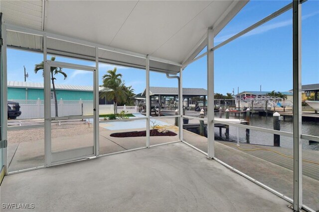 unfurnished sunroom featuring a water view and a wealth of natural light