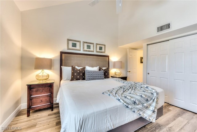 bedroom with light hardwood / wood-style floors and a closet