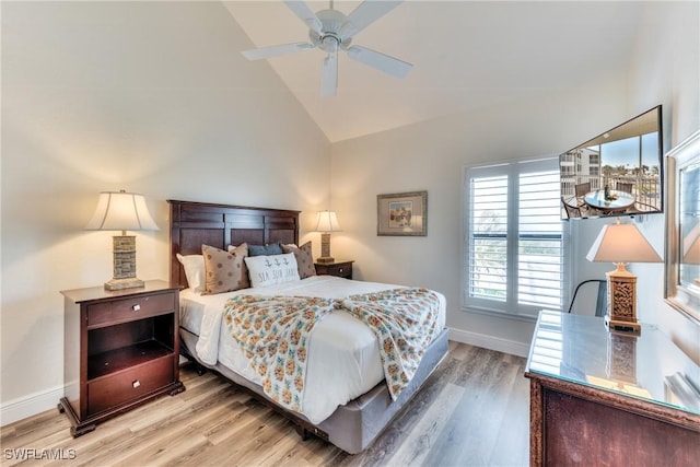 bedroom featuring ceiling fan, hardwood / wood-style flooring, and lofted ceiling