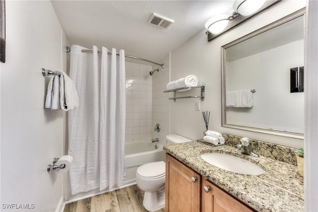 full bathroom with wood-type flooring, toilet, vanity, and shower / tub combo