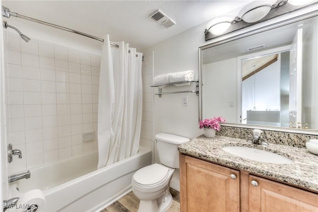 full bathroom featuring toilet, shower / tub combo, hardwood / wood-style flooring, and vanity