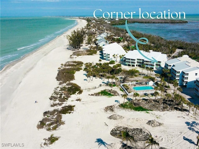 bird's eye view featuring a water view and a view of the beach