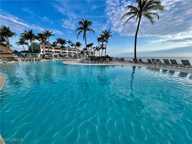 view of swimming pool featuring a water view