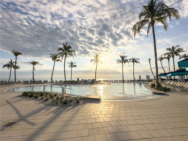 pool at dusk with a water view