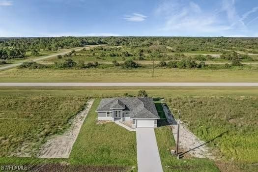 birds eye view of property with a rural view