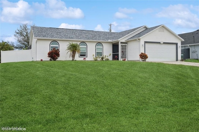 ranch-style house featuring a front yard and a garage