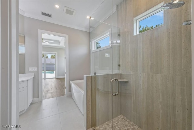 bathroom featuring tile patterned floors, vanity, crown molding, and plus walk in shower