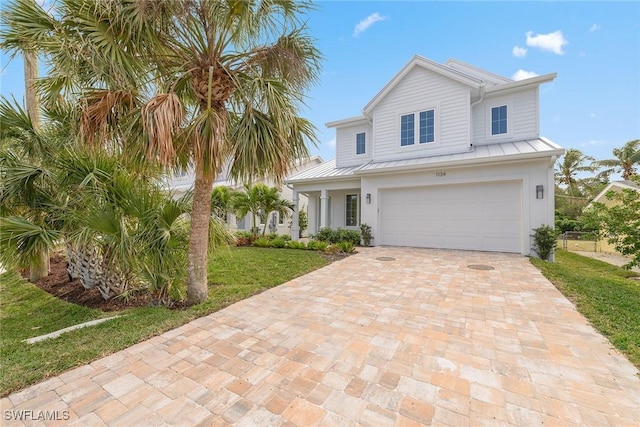 view of front of property featuring a garage and a front yard