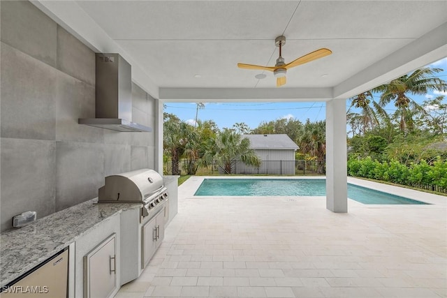 view of pool featuring area for grilling, exterior kitchen, and ceiling fan