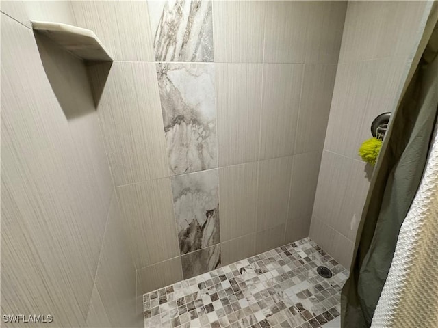 bathroom with tiled shower