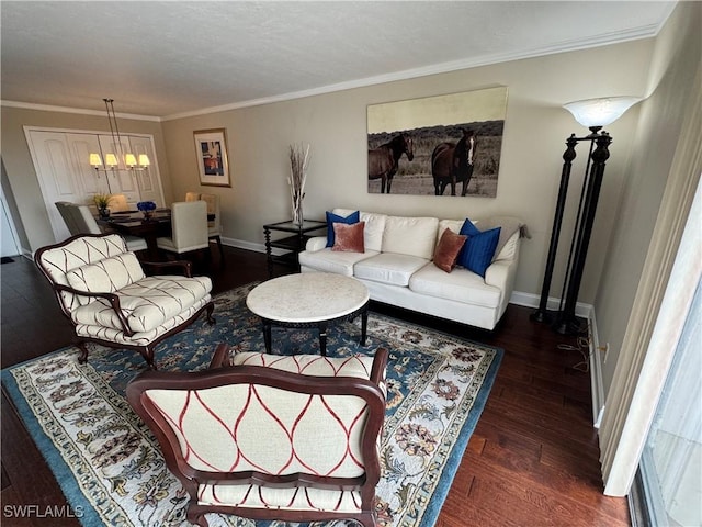 living room with a notable chandelier, ornamental molding, and dark hardwood / wood-style floors