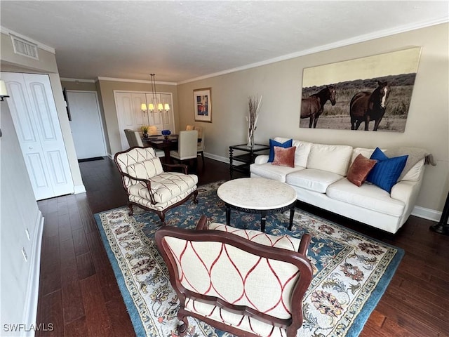 living room featuring crown molding, dark hardwood / wood-style floors, and a notable chandelier