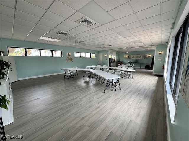 dining room with ceiling fan, plenty of natural light, and hardwood / wood-style flooring