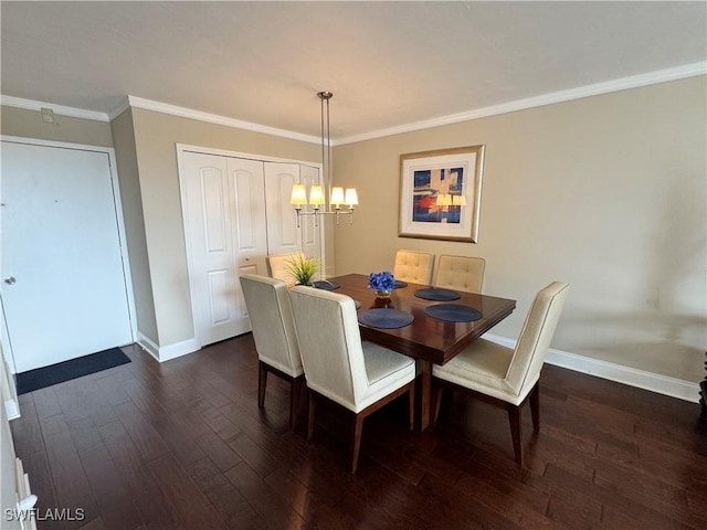 dining space featuring ornamental molding, dark wood-type flooring, and an inviting chandelier