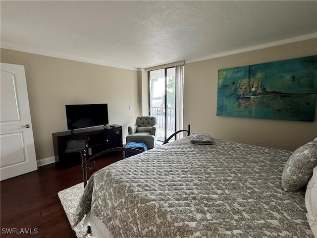 bedroom featuring access to exterior, a textured ceiling, dark hardwood / wood-style flooring, and ornamental molding