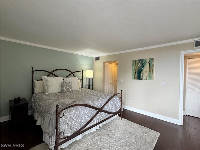 bedroom with dark hardwood / wood-style floors and crown molding