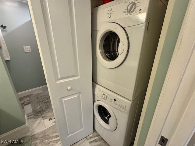 clothes washing area featuring stacked washing maching and dryer