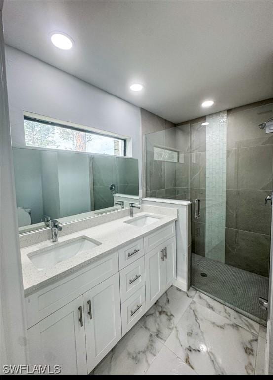 bathroom featuring vanity and a shower with door