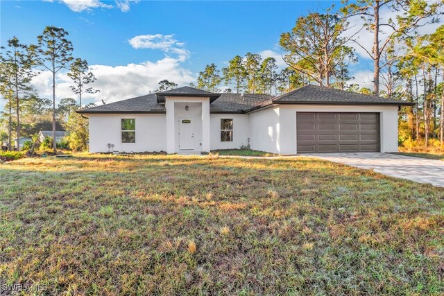 view of front of property with a garage and a front yard