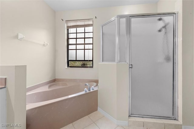 bathroom featuring tile patterned floors and independent shower and bath