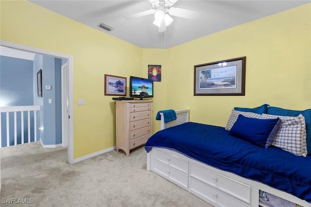 bedroom with ceiling fan and light carpet