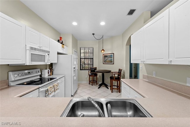 kitchen with white cabinetry, white appliances, sink, and hanging light fixtures