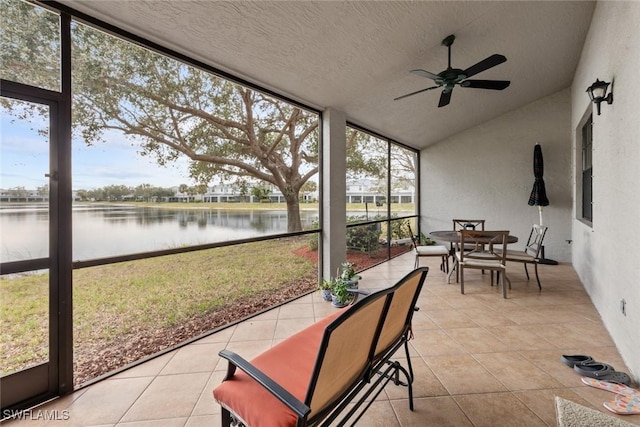 sunroom featuring a water view, ceiling fan, and lofted ceiling