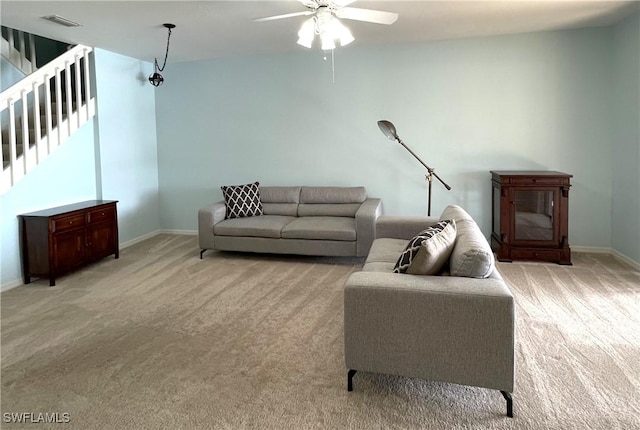 carpeted living room with ceiling fan