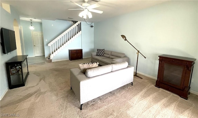 carpeted living room featuring ceiling fan