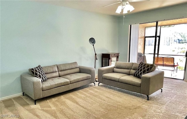 carpeted living room with ceiling fan