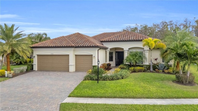 mediterranean / spanish-style house with a front yard and a garage