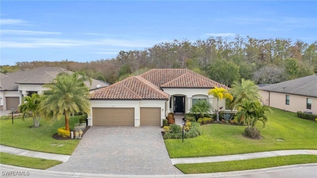 mediterranean / spanish home with a front lawn and a garage