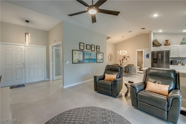 living room featuring lofted ceiling, light tile patterned floors, and ceiling fan with notable chandelier