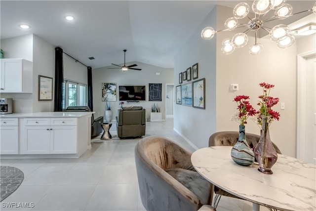 dining area featuring lofted ceiling, ceiling fan, and light tile patterned flooring