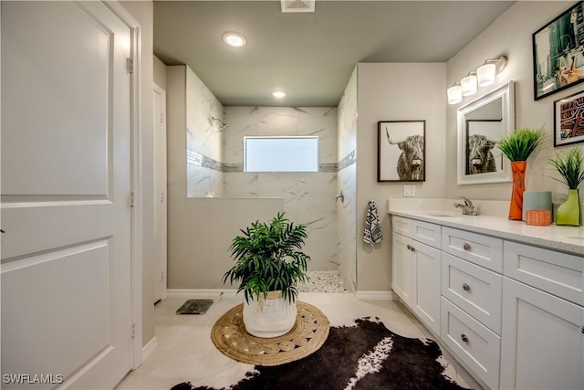 bathroom featuring vanity and a tile shower