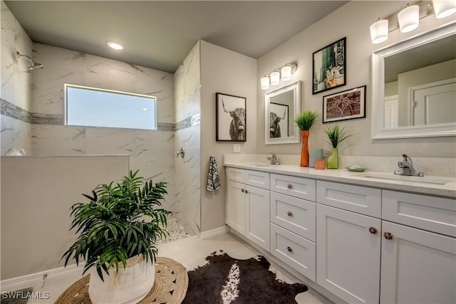 bathroom featuring vanity and tiled shower