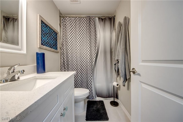 bathroom with tile patterned floors, vanity, toilet, and walk in shower